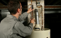 Contractor repairing old water heater