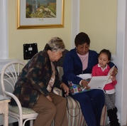 Young Child Reading to Seniors