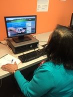 Ms. Jackie on the computer registering for Smart911