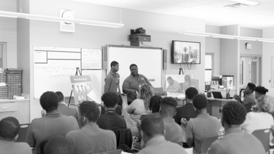 New Hires Standing in Front of Classmates