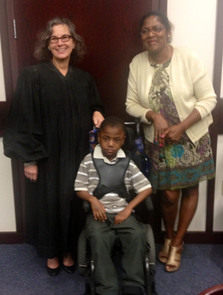 Judge Katherine Essrig with La’Trell and his adoptive mother, Susan Ambrose.