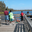 A family fishes off the Lake Dixie Pier in Lake Louisa State Park.