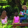 Volunteer Julie Wilkinson reads with two children at Alfred B. Maclay Gardens State Park.