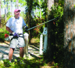 Volunteer Bill Ellsworth trims a tree at Dr. Julian G. Bruce St. George Island State Park.