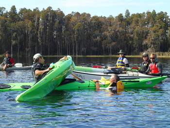 students in class right a kayak, by Liz Sparks