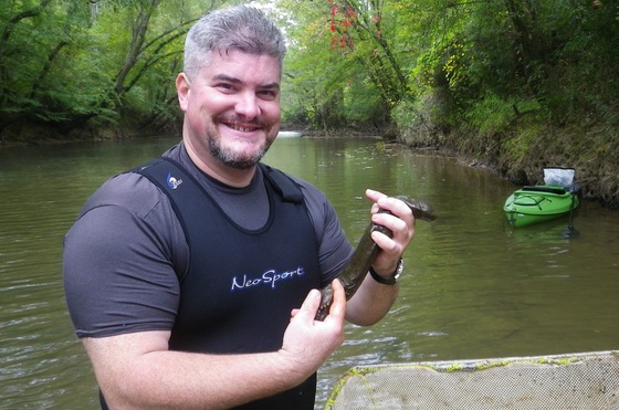 Biologist Thomas Floyd with hellbender in Mississippi.