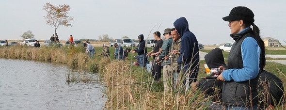 A group of people fishing for trout stocked by the Iowa DNR.