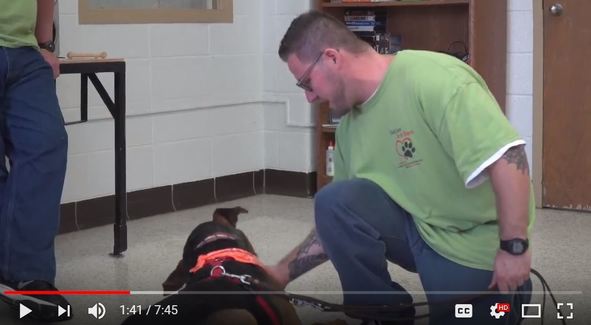 An image of a dog and inmate enrolled in the program. 