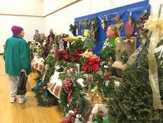 Woman shopping for poinsettias at holiday market