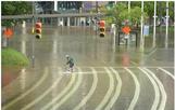 image of biker riding through floodwater in downtown Baltimore