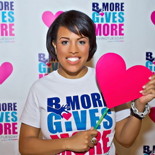 IMAGE: Mayor Rawlings-Blake holds a bright paper heart and sports a Bmore Gives More t-shirt.