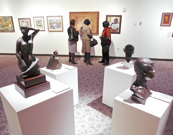 IMAGE: Visitors browse the Kinsey Collection at the Reginald F. Lewis Museum