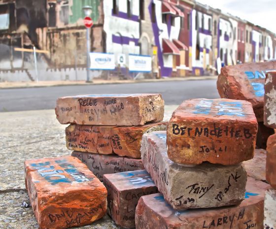 IMAGE: A pile of bricks represents the innovative deconstruction of vacant houses like those in the image background