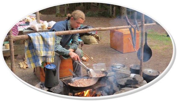 Camping over an outdoor fire at and Aroostook Wilderness waterway campsite.