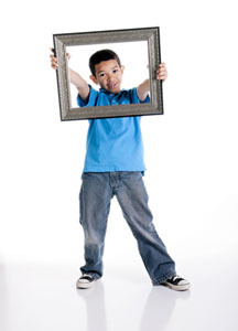 Photo of Boy in Blue Shirt Holding Art Frame