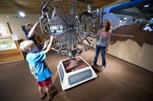 People looking at exhibit at Michigan Iron Industry Museum