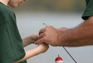 Two people baiting a fishing hook