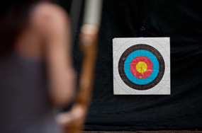 woman with archery equipment and target