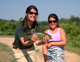 Child fishing at Wolf Lake State Fish Hatchery