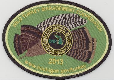The winning design for the 2013 Michigan Wild Turkey Cooperator patch features feathers from a turkey’s breast, wing and tail.