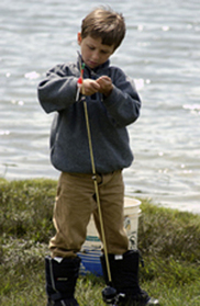 Young boy learning to fish