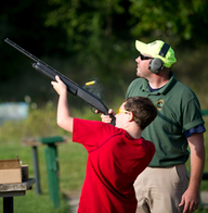 DNR employee helps youth at a shooting range