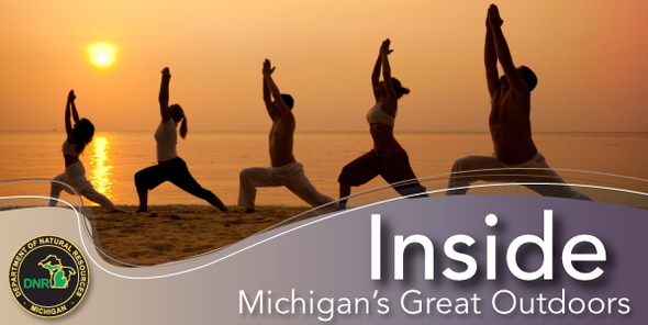 People stretching on the beach at sunset