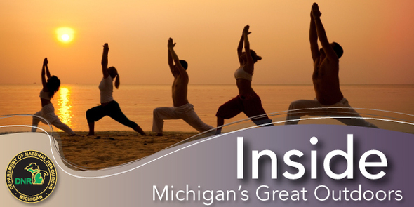 People stretching on the beach at sunset