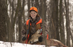 Young female hunter with deer