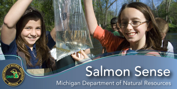 Young girls holding salmon in a plastic bag