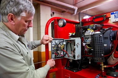 Completing electrical circuits on a fire engine at the Forest Fire Experiment Station
