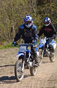 Two off-road vehicle riders on a Michigan trail.