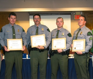 Four Michigan DNR conservation officers holding Lifesaving Awards
