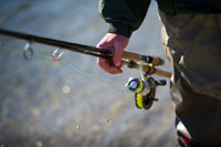 Close-up of fishing equipment in angler's hand