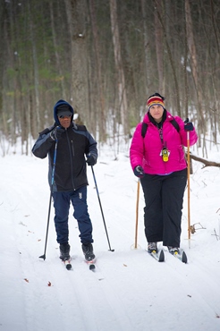 man and woman cross-country skiing