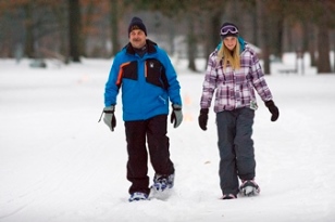 Man and woman snowshoeing in winter