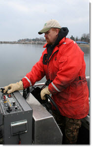Fisheries Division employee driving a boat