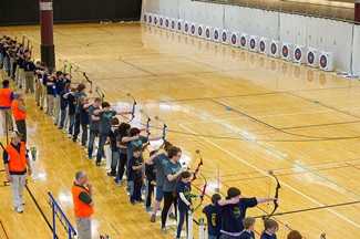 Student archers lined up to shoot at targets