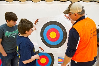 Student archers remove their target after shooting