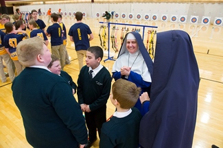 Students discuss the competition at archery tournament