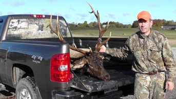 hunter with elk in truck