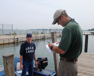 DNR creel clerk talking to fisherman
