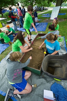 kids working on an archaeological dig in Lansing