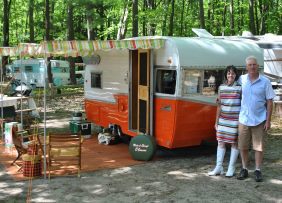 Campers in front of their vintage trailer