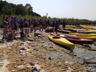 People prepare to kayak during a kayaking class.