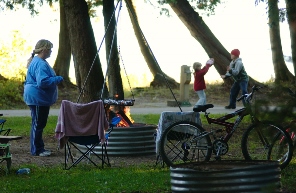 woman and two children enjoying a campfire at a Michigan state park