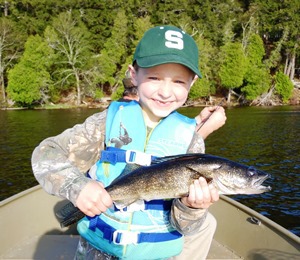 young boy holding a walleye
