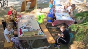 campground host helping kids with craft project