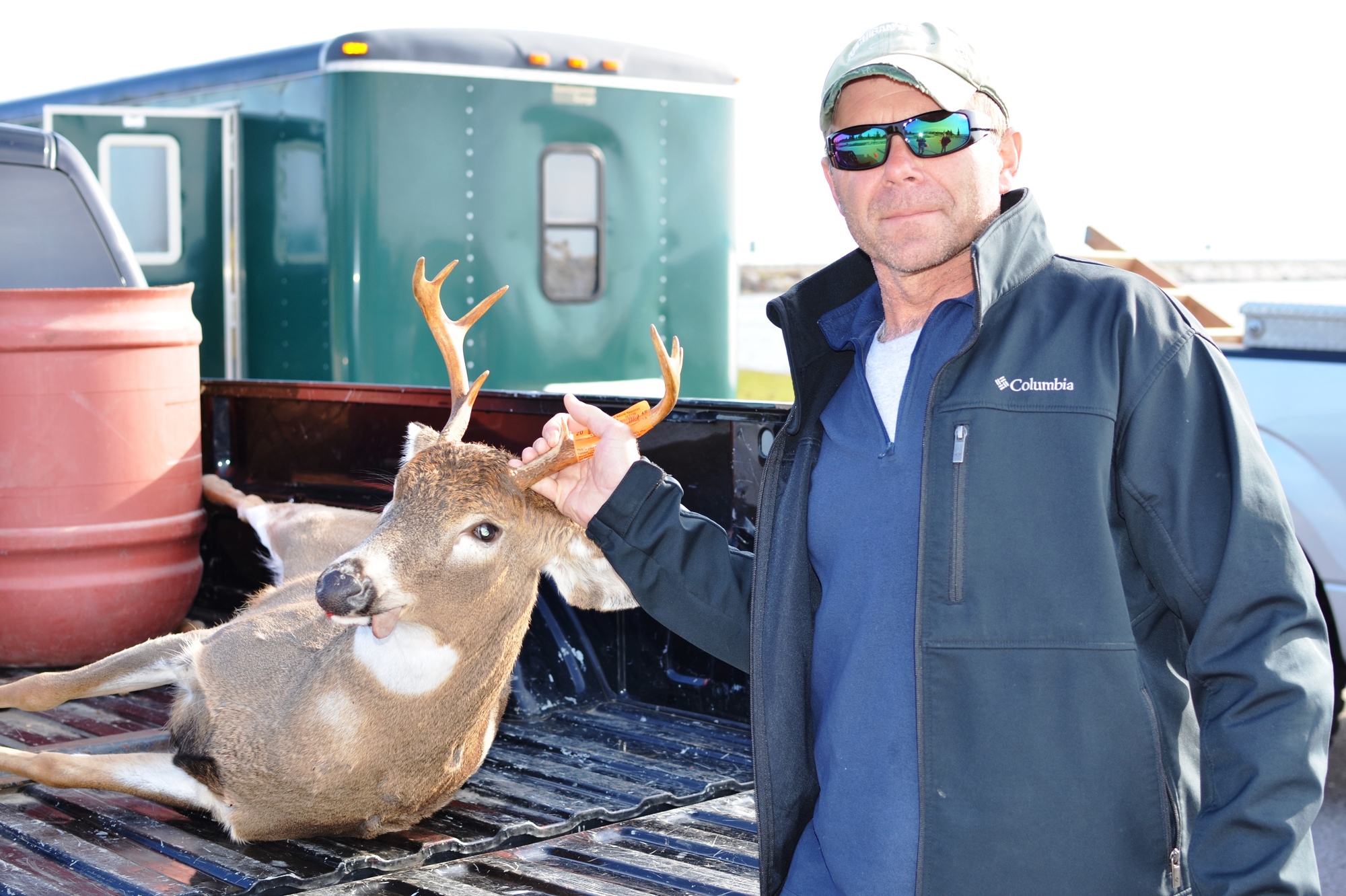 A hunter with his buck at the Mackinac Bridge check station.