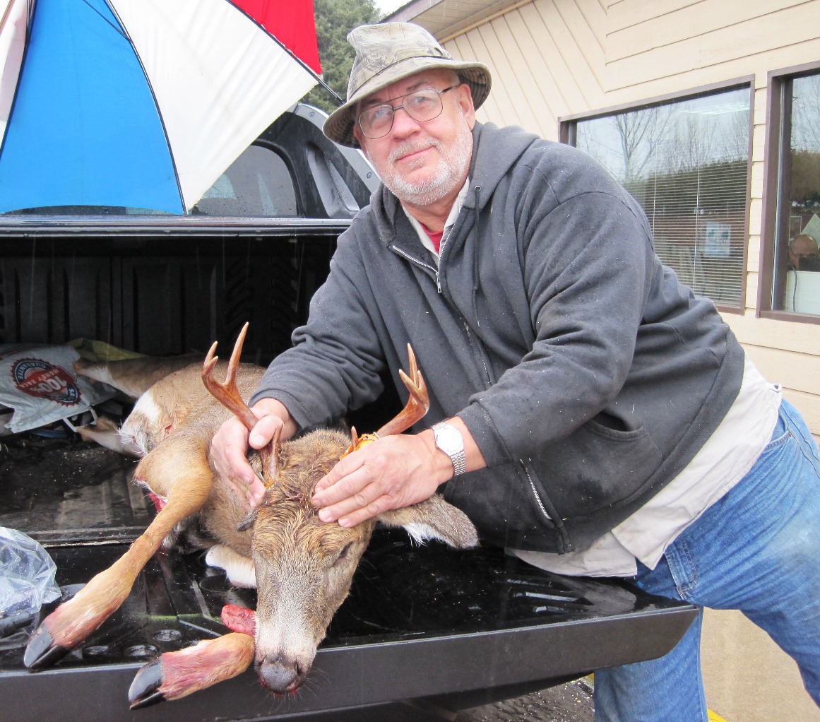 A hunter with his deer at the Newberry check station.